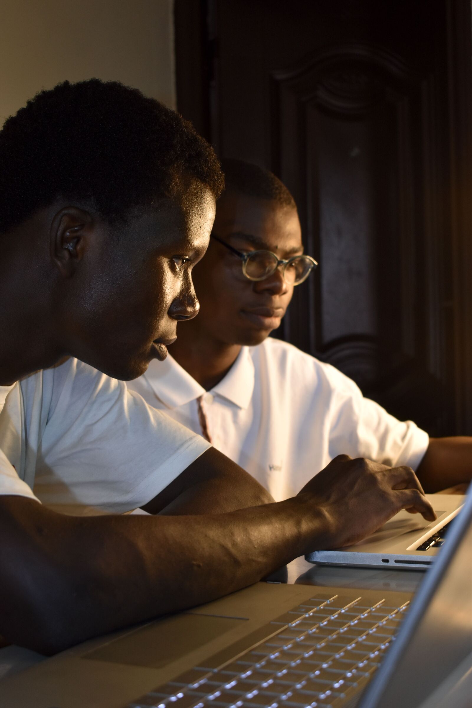 A student and her mentor working together at a laptop